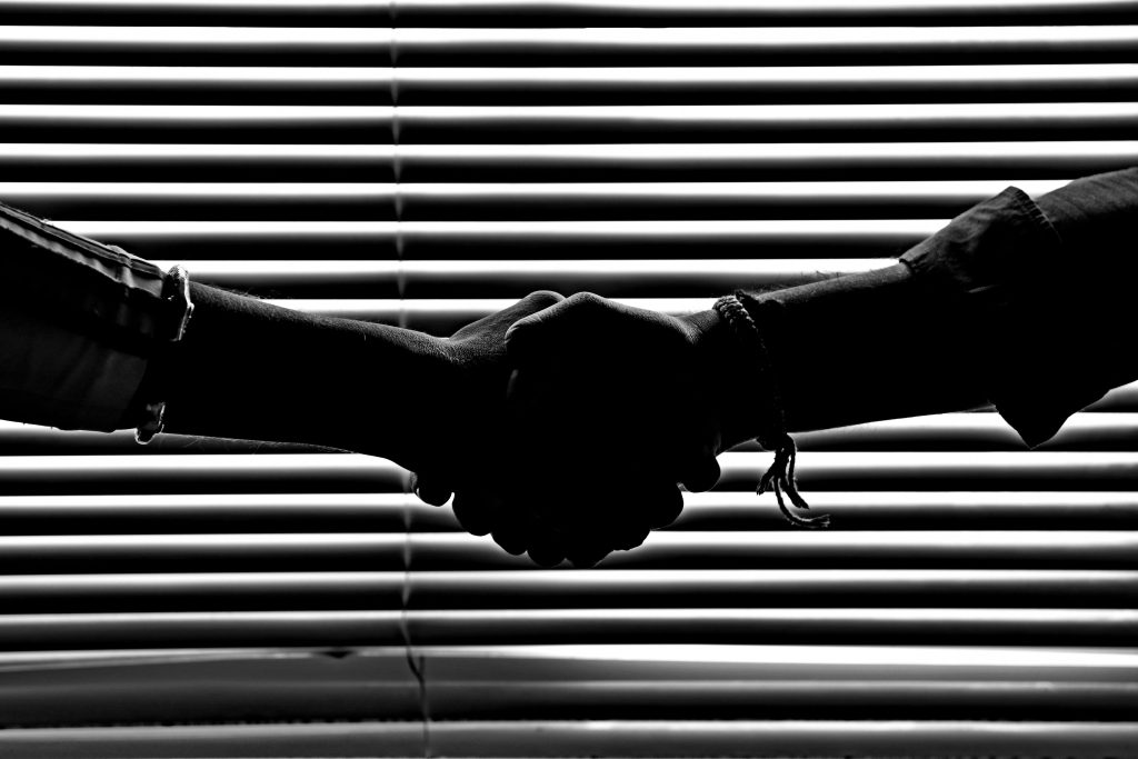 pexels-photo-814544-814544 Silhouette of two people shaking hands symbolizing partnership and trust.
